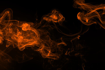 Fluffy puffs of orange smoke and fog on black background, fire design