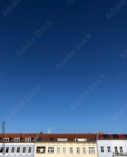 view of the rooftops and blue sky from the window, Germany © in_colors