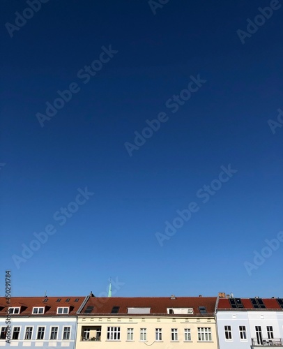 view of the rooftops and blue sky from the window, Germany