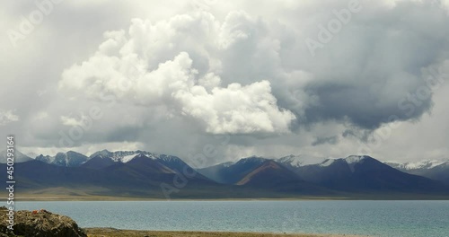 4k time lapse of huge clouds mass rolling over lake namtso & Tanggula snow mountain peak,tibet mansarovar,Tibet's second largest lake,is the third largest saltwater lake in China.Danggula(Tanggula) Mo photo