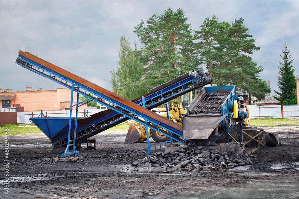Portable coal belt conveyor, coal industry. Coal mining, environmental pollution. Fossil fuels packing and sales business Portable coal belt conveyor, coal industry. Coal mining, environmental pollution. Fossil fuels packing and sales business