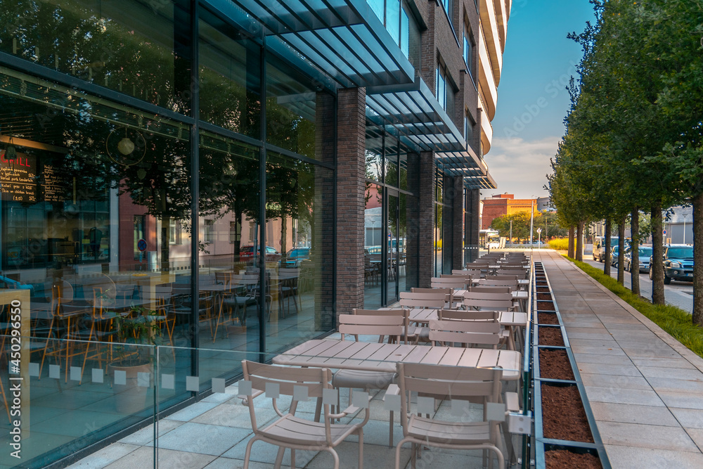 Empty street cafe. Empty tables and chairs of a street cafe. No visitors. Empty street cafe. Empty tables and chairs of a street cafe. No visitors.