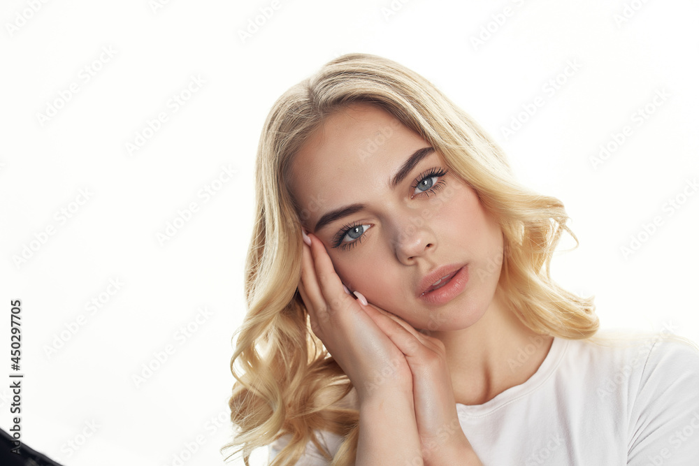 pretty blonde holding her head posing face close up pretty blonde holding her head posing face close up