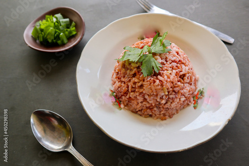 red rice, Red steamed rice or nasi merah served in plate isolated on black background