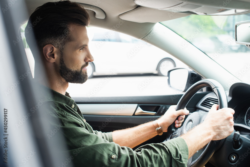 Side view of brunette man driving car Side view of brunette man driving car