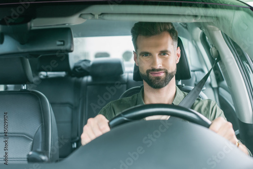 Man looking at camera while driving car © LIGHTFIELD STUDIOS