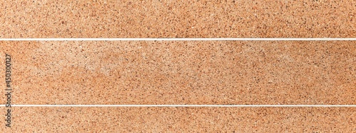 Panorama of Brown granite tile floor outside the building pattern and seamless background