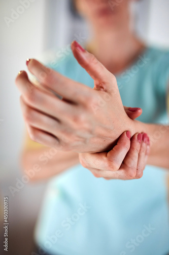 Woman with hand and arm pain at home.