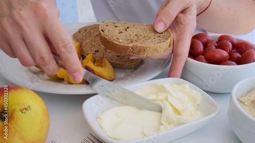 Women's hands are preparing toast with kaymak or butter. Healthy breakfast concept. photo