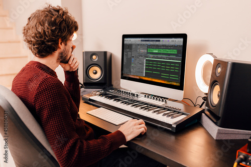 Music producer working at home music studio photo