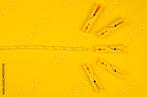 Yellow clothespins and rope. Lucky break concept. photo