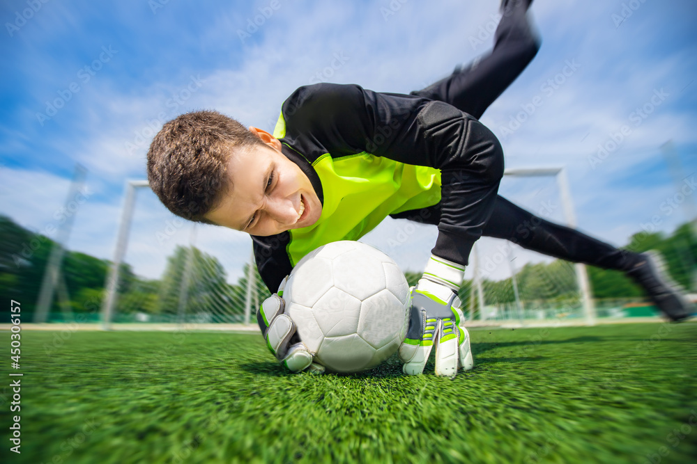 Goalkeeper soccer man catching ball in stadium, action sport moment Goalkeeper soccer man catching ball in stadium, action sport moment