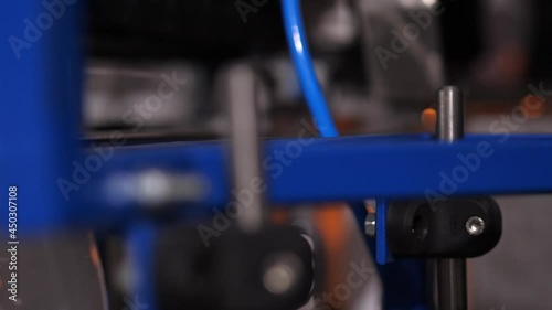 Honed automated operation of the blue machine on the conveyor production of plastic bottles.