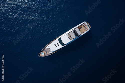 Super yacht on blue water top view. A huge white super Mega yacht on blue water in Italy. White yacht open sea aerial view.h