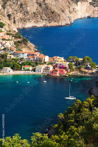 Close up top view at Asos village, Assos peninsula and fantastic blue Ionian Sea water. Aerial view, summer scenery of famous and extremely popular travel destination in Cephalonia, Greece, Europe.