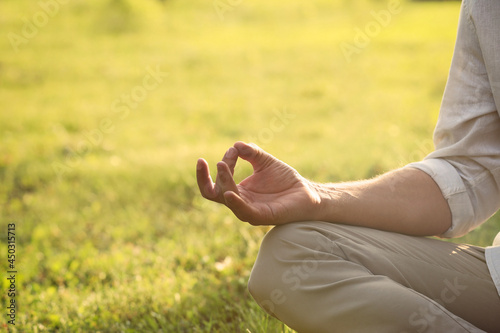 Man meditating outdoors on sunny day, closeup. Space for text © New Africa