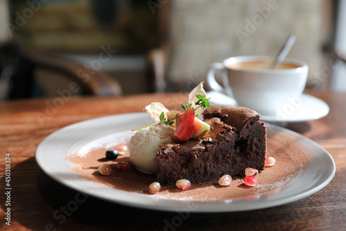 Chocolate cake with ice cream and coffee dessert on wood table