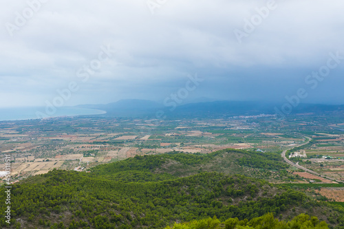 Spanish plains and hills from the Santa Llucia belvedere (Alcossebre-Alcala de Xivert, Spain). Beautiful view of magnificent nature. Cloudy day on the panoramic spot.