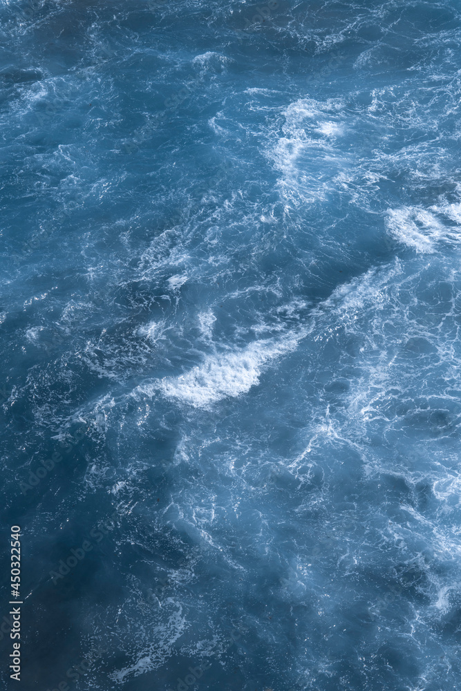 Aerial view of the ocean waves. Blue water background abstract texture