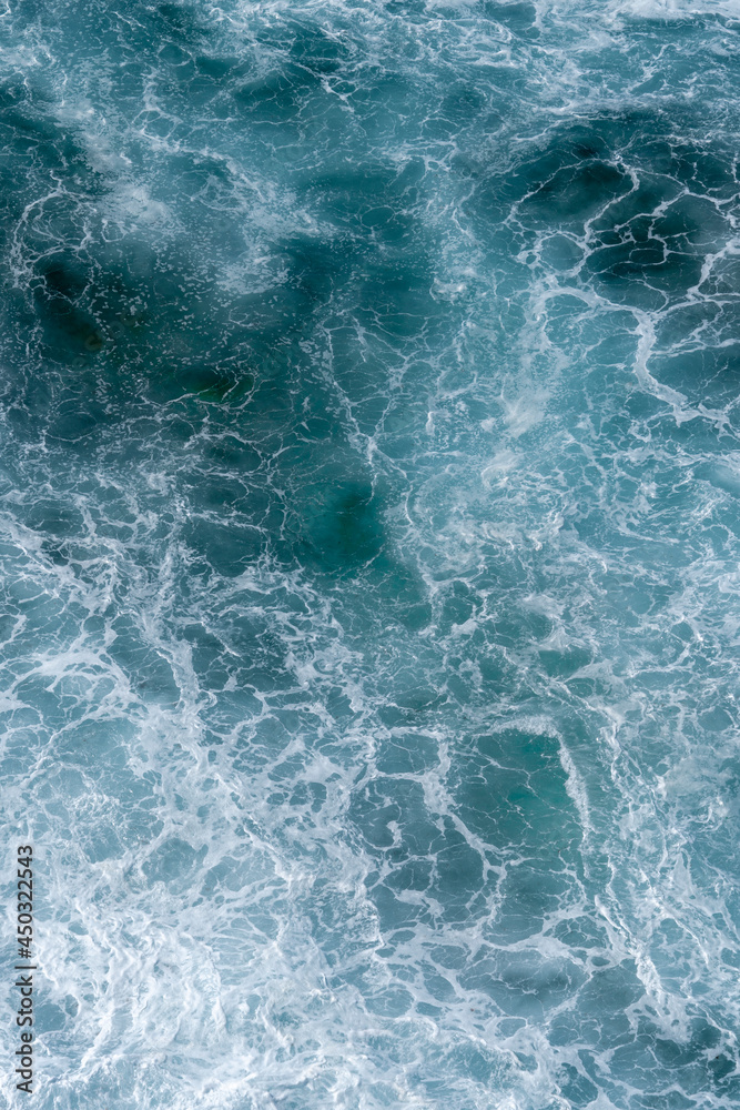 Fototapeta premium Aerial view of the ocean waves. Blue water background abstract texture