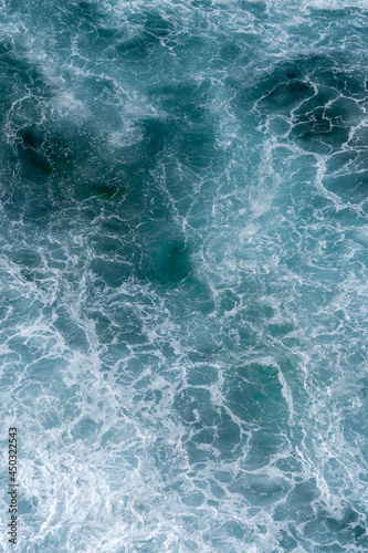 Aerial view of the ocean waves. Blue water background abstract texture