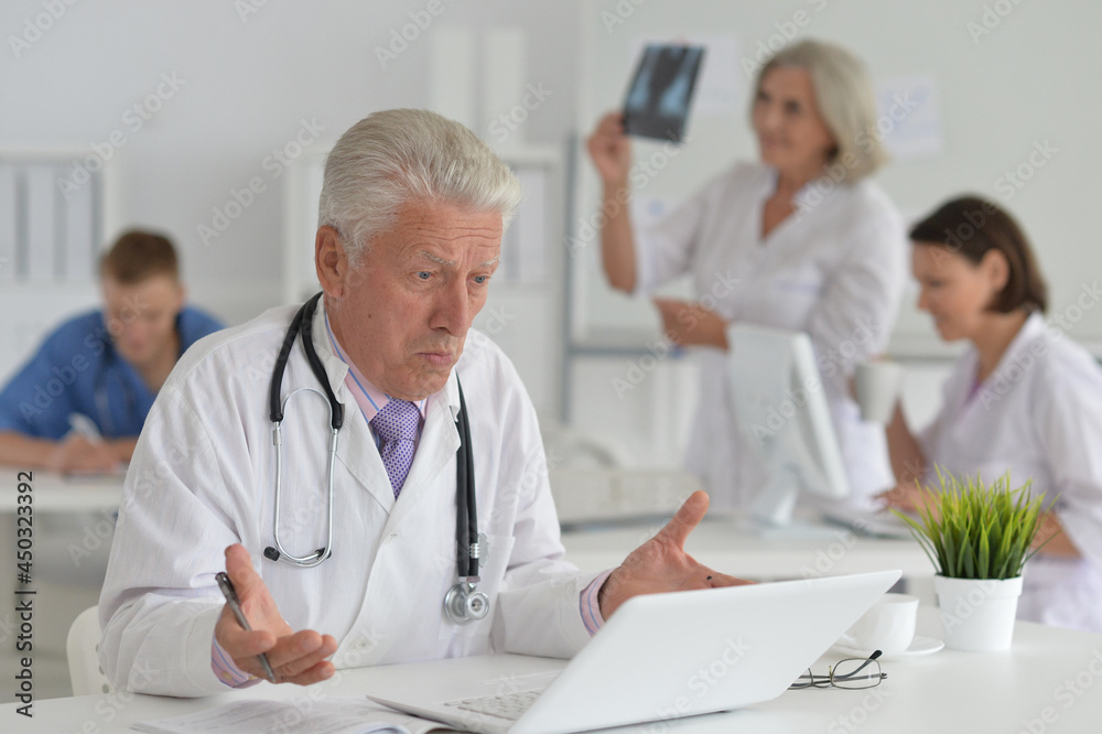 Portrait of a senior doctor working at hospital Portrait of a senior doctor working at hospital