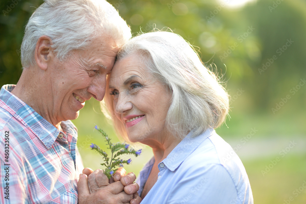 senior couple posing in the park senior couple posing in the park