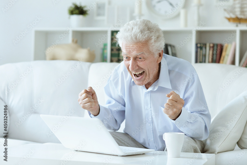 senior man using laptop at home senior man using laptop at home