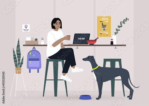 A female freelancer having lunch with their pet in a dog friendly cafe, a counter with bar stools