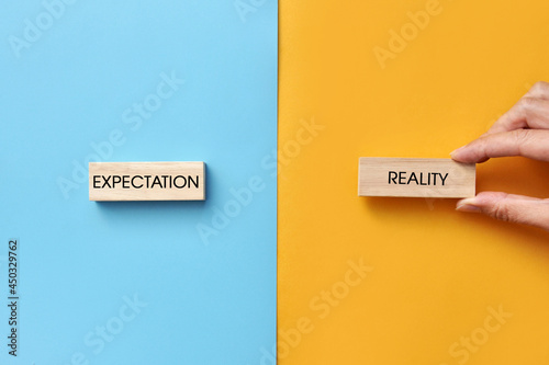 Wooden plates with the inscription: expectation and reality. A symbol of the difference between expectation and reality