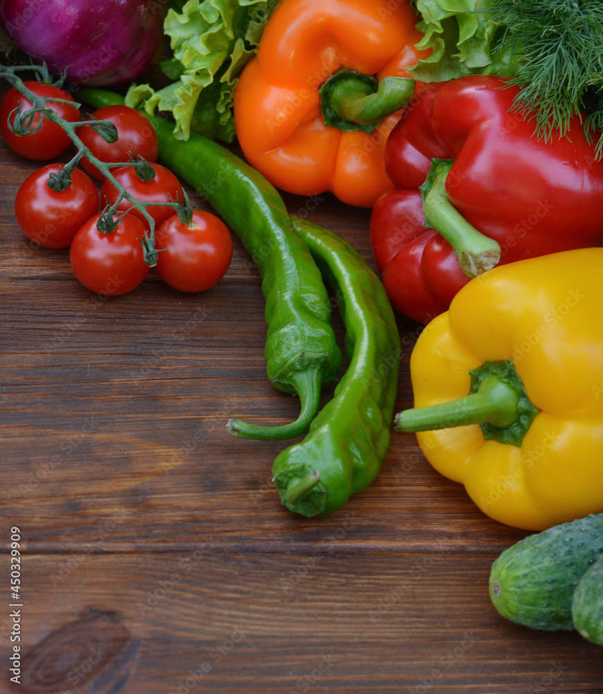 A set vegetables on a wooden background: carrots, potatoes, zucchini, paprika, cucumber, garlic, tomatoes, lettuce.Healthy food concept with vegetables and ingredients for cooking. Top view.Copy space A set vegetables on a wooden background: carrots, potatoes, zucchini, paprika, cucumber, garlic, tomatoes, lettuce.Healthy food concept with vegetables and ingredients for cooking. Top view.Copy space