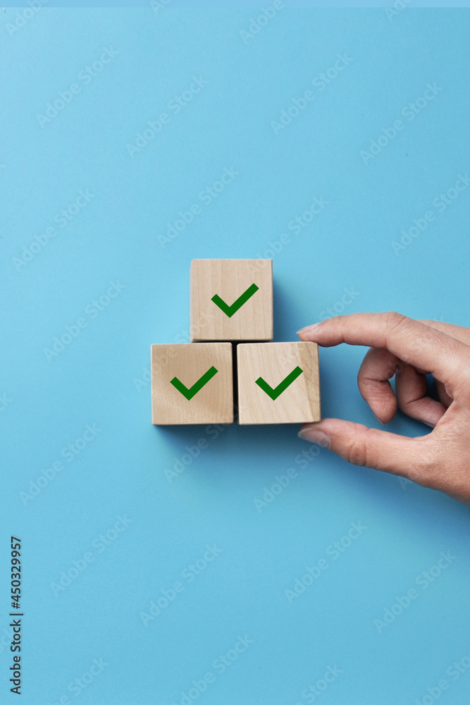 Wooden blocks with drawings of checkmarks. A symbol of consent and correct choice Wooden blocks with drawings of checkmarks. A symbol of consent and correct choice