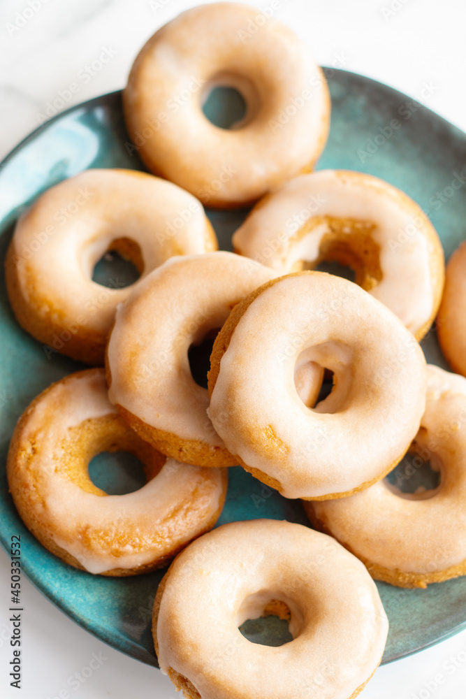 Home made baked whole wheat vegan donuts with orange glaze Home made baked whole wheat vegan donuts with orange glaze
