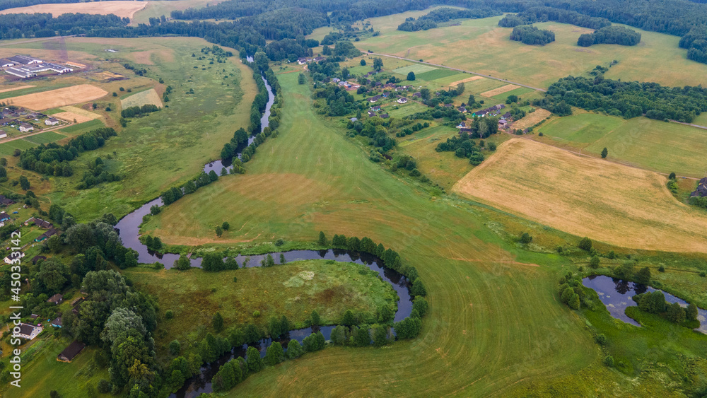 Aerial landscape of winding river in green field, top view of beautiful nature background from drone, seasonal summer landscape with copy space. Aerial landscape of winding river in green field, top view of beautiful nature background from drone, seasonal summer landscape with copy space.