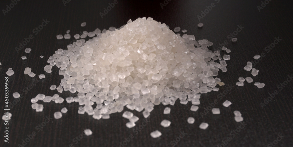 Sugar in glass bowl on wooden background. Sugar in glass bowl on wooden background.