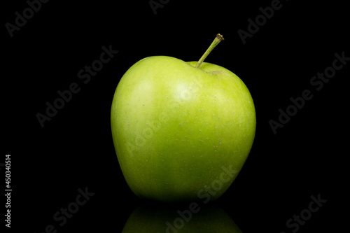 Green apple on a black background.