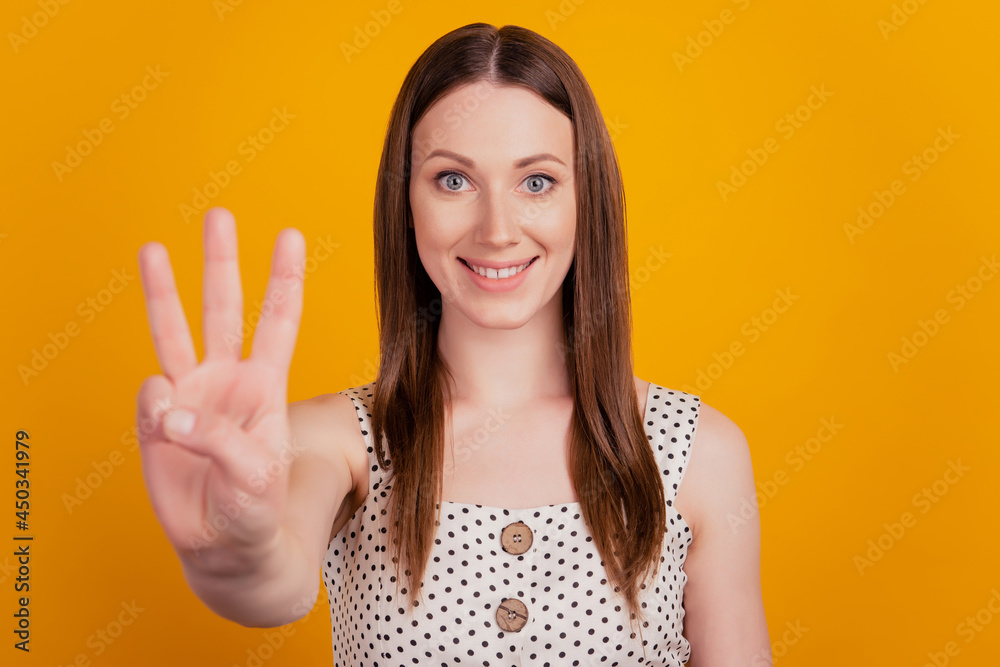 Portrait of positive lovely lady count fingers show three on yellow background Portrait of positive lovely lady count fingers show three on yellow background