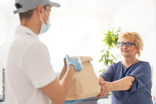 Food delivery to an elderly woman during quarantine Coronavirus Covid-19 epidemic © Angelov