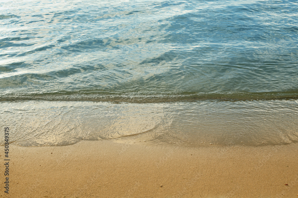 sea ​​sandy shore background, the wave runs on the coastal sand, the concept of recreation, travel, vacation