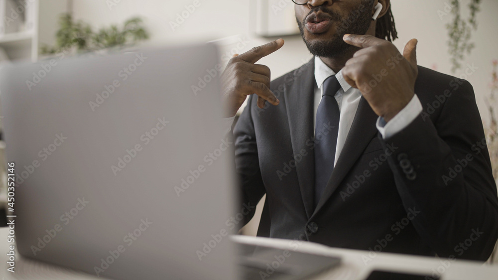 Black language teacher in suit having online lesson on laptop, distance work Black language teacher in suit having online lesson on laptop, distance work