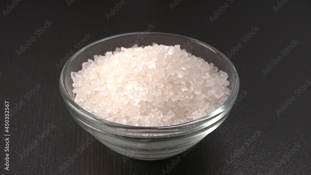 Bowl and spoon with sugar on wooden background. Bowl and spoon with sugar on wooden background.