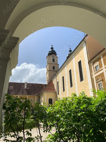 Stainz, Austria, June 23, 2021. Stainz Castle in the Austrian state of Styria. Today the Baroque complex belongs to the Counts of Merano. View of the towers with bell towers 