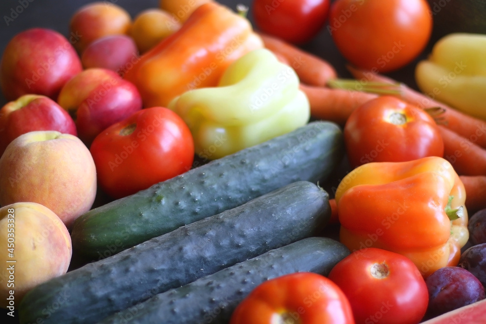 Various colorful summer fruit and vegetable on dark background. Selective focus. Various colorful summer fruit and vegetable on dark background. Selective focus.