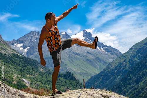 Male hiker enjoying the hot summer in the Alps during hike photo