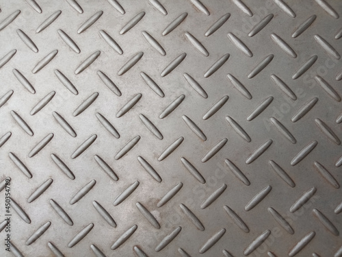 Stainless steel plate with diamond pattern, silver metal floor texture surface for background or design, seamless texture metallic