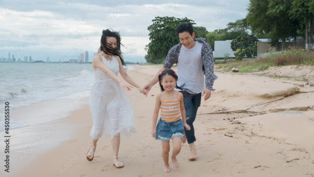 Asian Family playing at beach with kids happy vacation concept Asian Family playing at beach with kids happy vacation concept