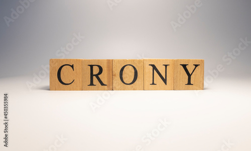 Crony was created from wooden cubes. News and journalism concepts.