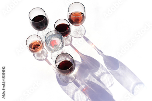 Wine of different varieties in glasses on a white background.