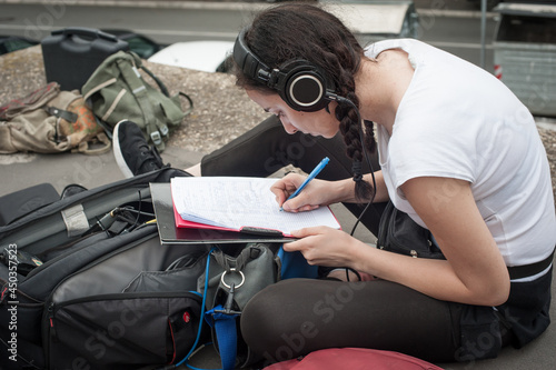 Sound director technician with headset writing sound recorder audio script photo