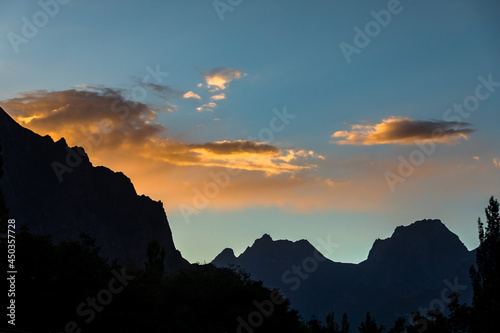 Sunset mountains silhouette cloudy evening. High quality photo
